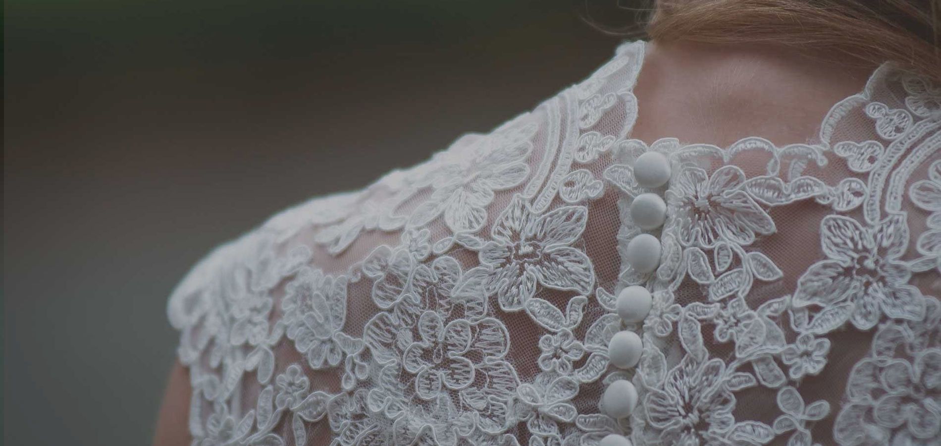 Close detail of hand-beaded bridal lace on a wedding gown