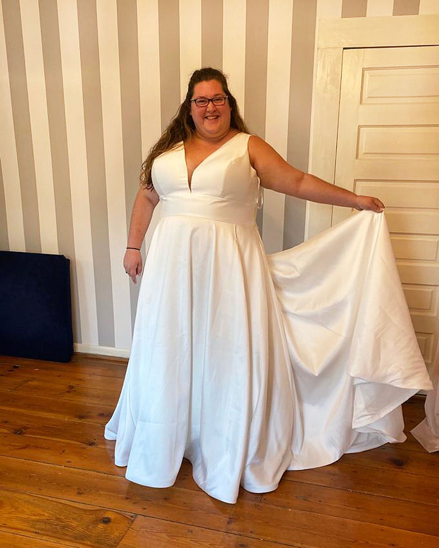 Satin wedding gown pressed and ready for collection at Nina’s Sandy Springs studio
